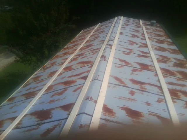 Rusted metal roof panels with new wood purlins before replacement — Storm Damage Roof Repair in Helmetta by Roofing Brothers