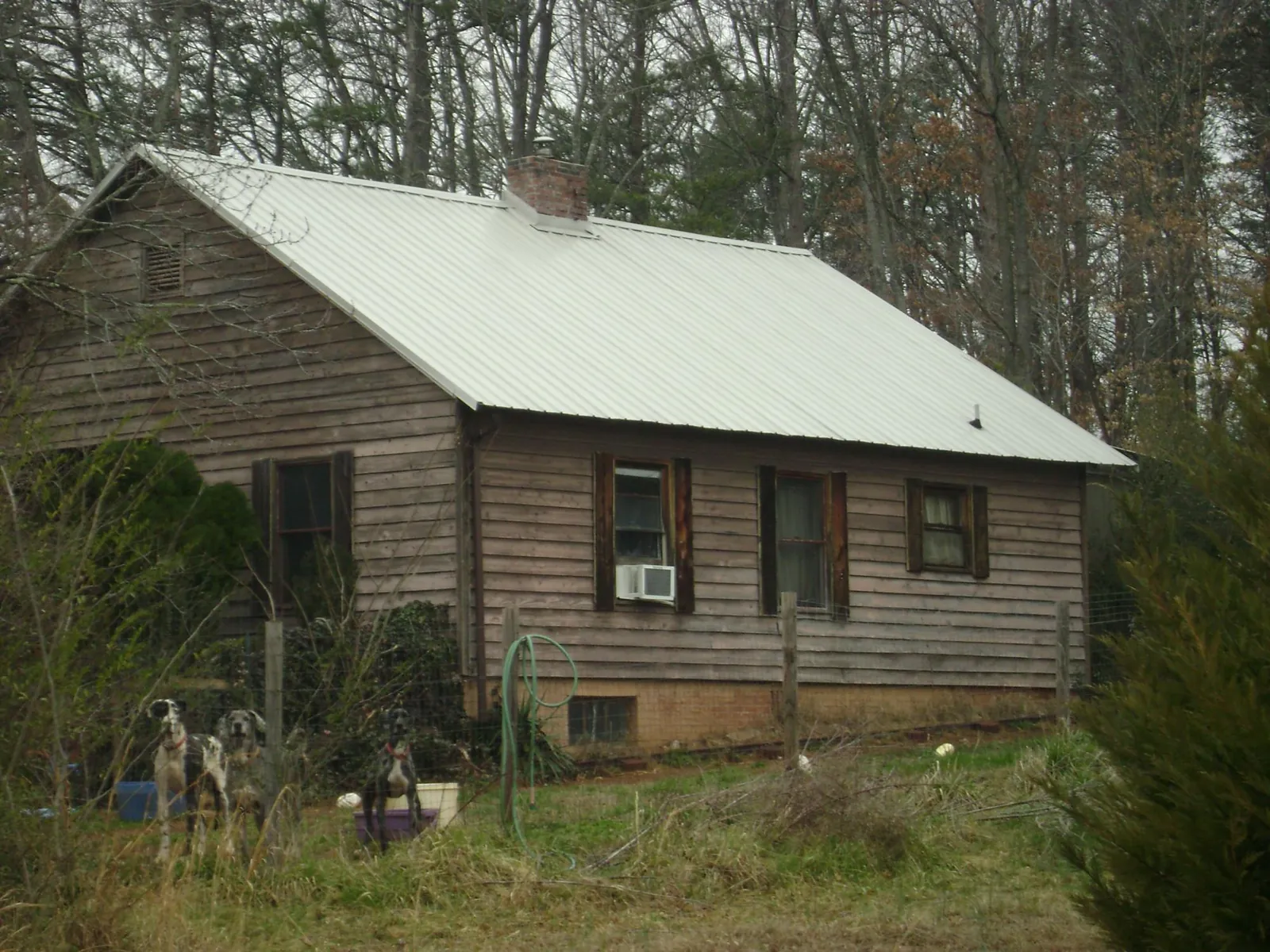 White metal roof on an old wood sided farmhouse, from a Metal Roof Installation job in Helmetta